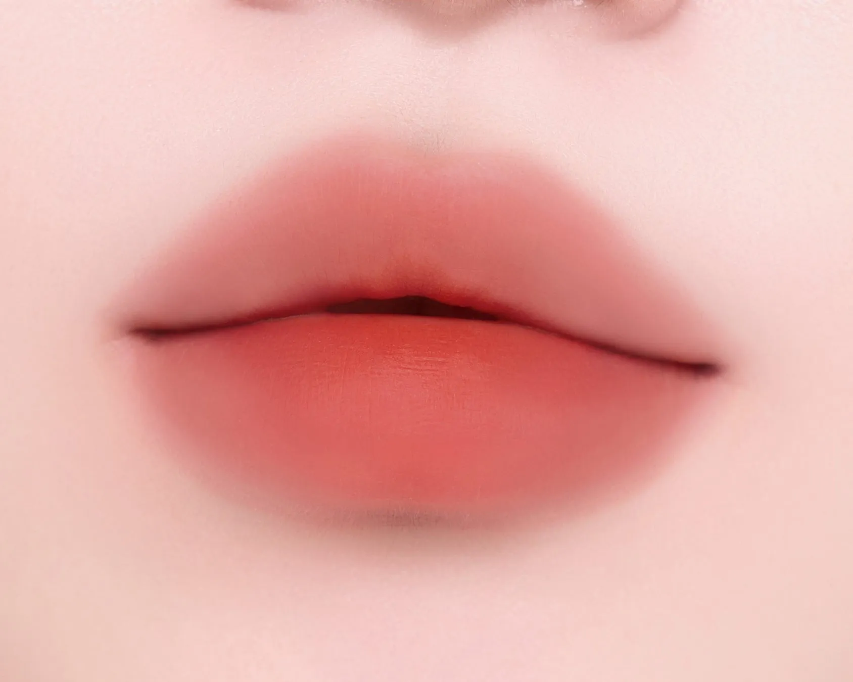 唇のアップ。オレンジ色のリップメイクが施されている.